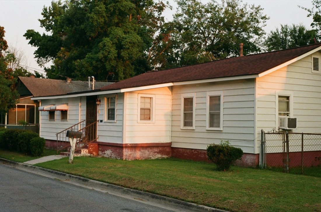 A modest single-story home in warm evening light
